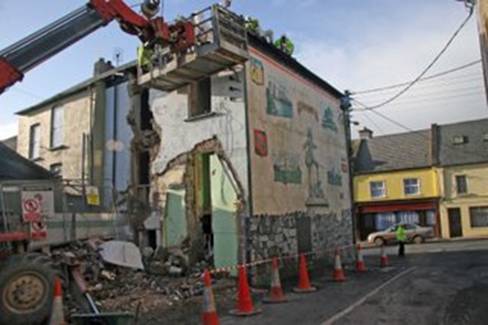 Workmen_begin_the_demolition,_Treacy's_pub_in_Bruff,_with_it's_famous_mural__